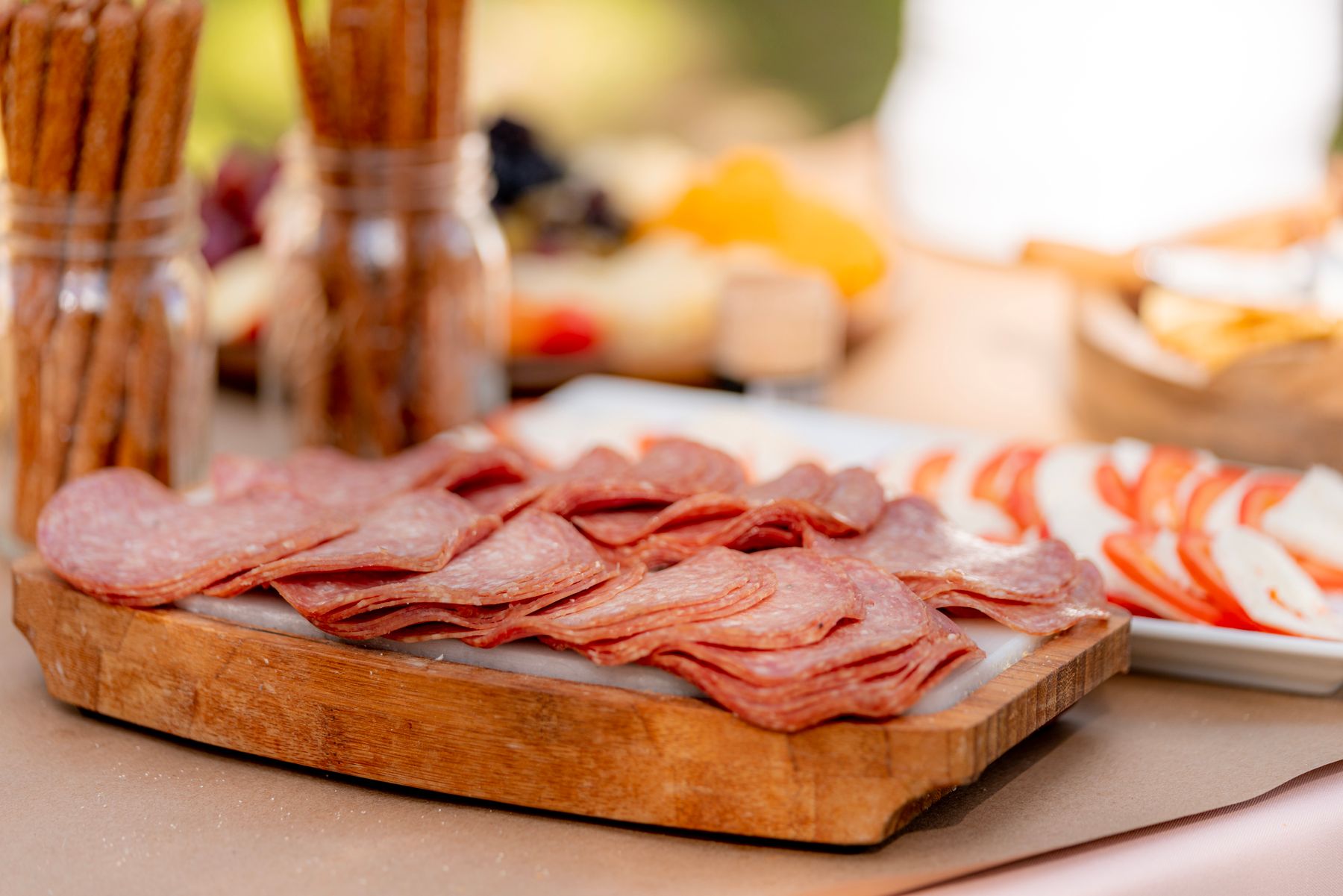 Platte mit Salami, Tomate und Mozzarella auf einem Holzbrett